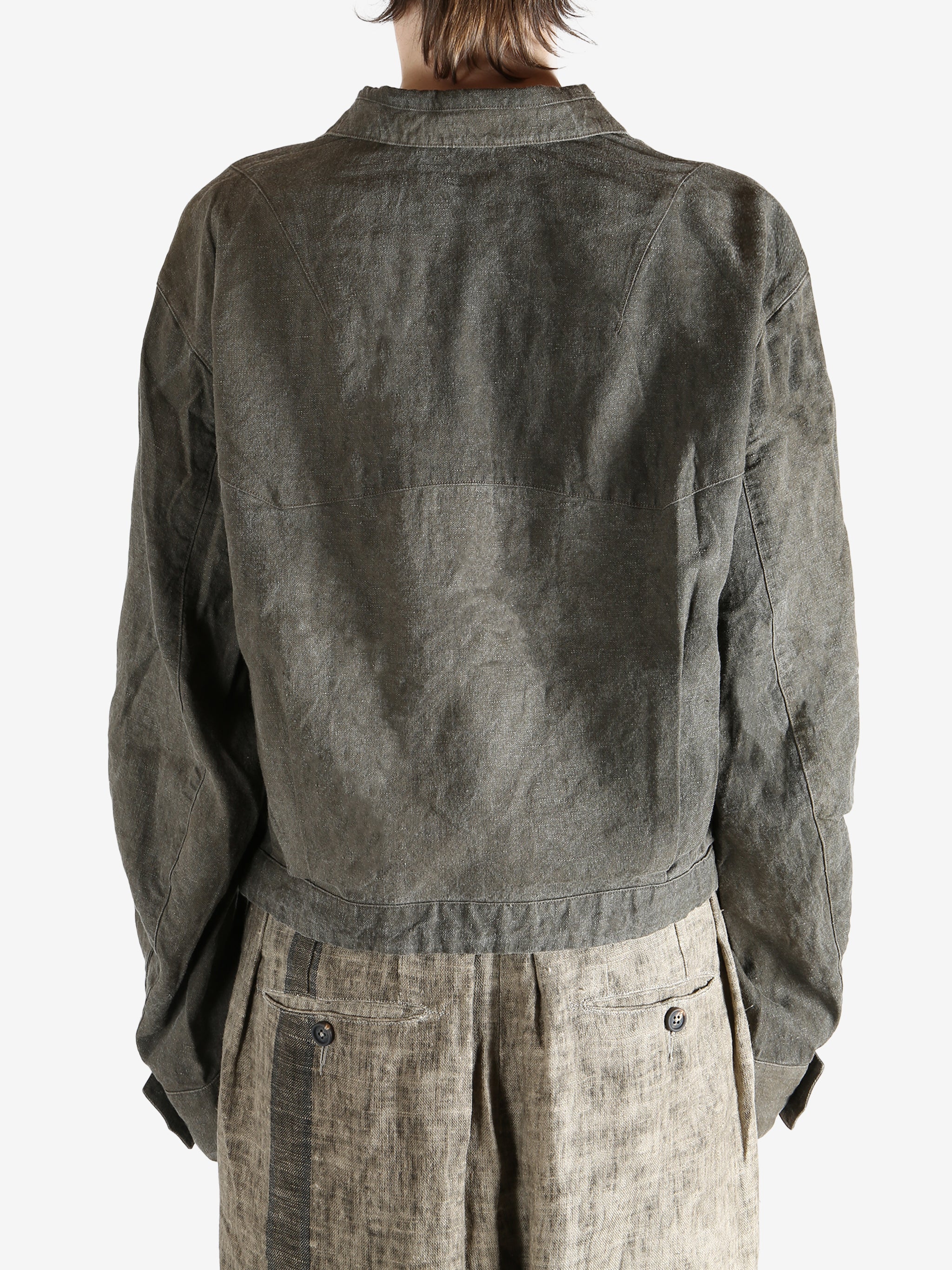 Green jacket worn by a person, showing the jacket fit