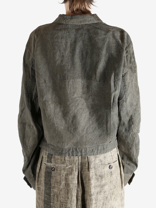 Green jacket worn by a person, showing the jacket fit