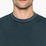 Close up of blue shirt worn by a person, showing the shirt's fit