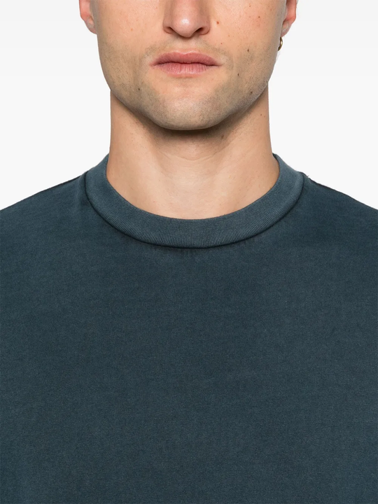 Close up of blue shirt worn by a person, showing the shirt's fit