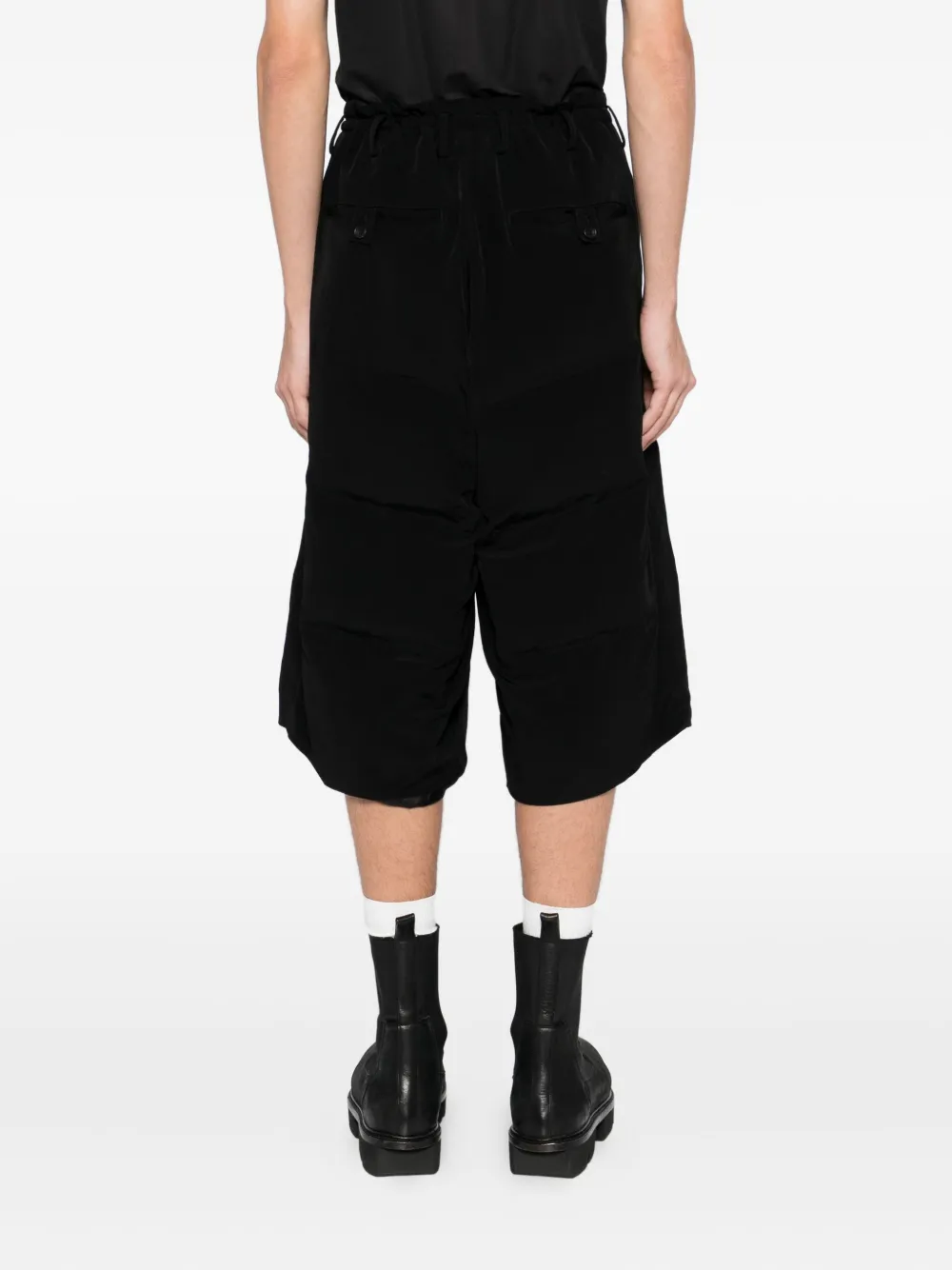 Black pants worn by a person, showing the pants fit