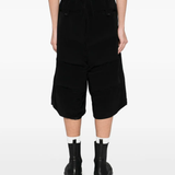 Black pants worn by a person, showing the pants fit