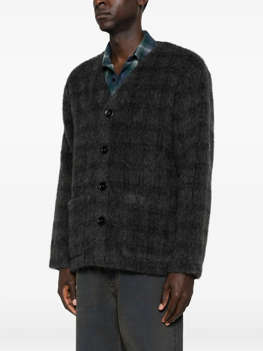 grey knitwear worn by a person, showing the knitwear fit