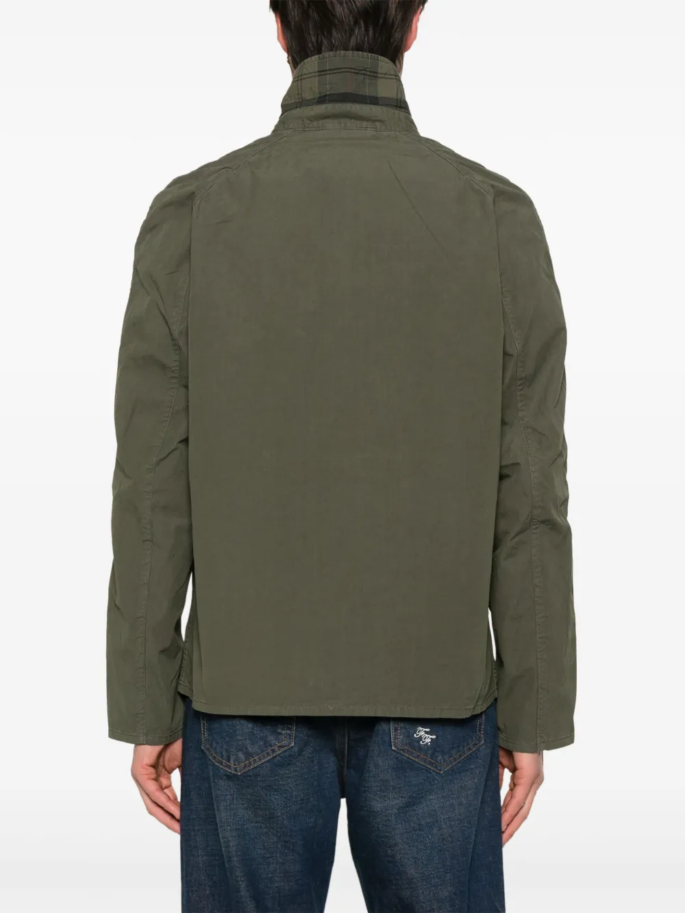 Green jacket worn by a person, showing the jacket's fit