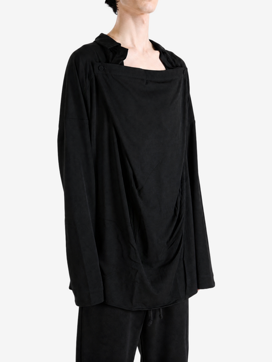 Black shirt worn by a person, showing the shirt fit