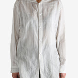 White shirt worn by a person, showing the shirt's fit