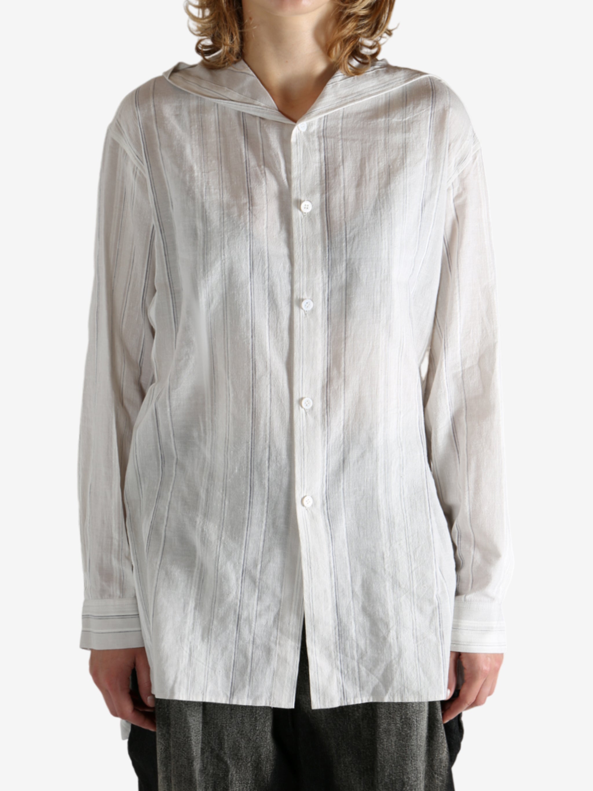 White shirt worn by a person, showing the shirt's fit