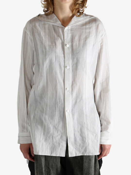 White shirt worn by a person, showing the shirt's fit