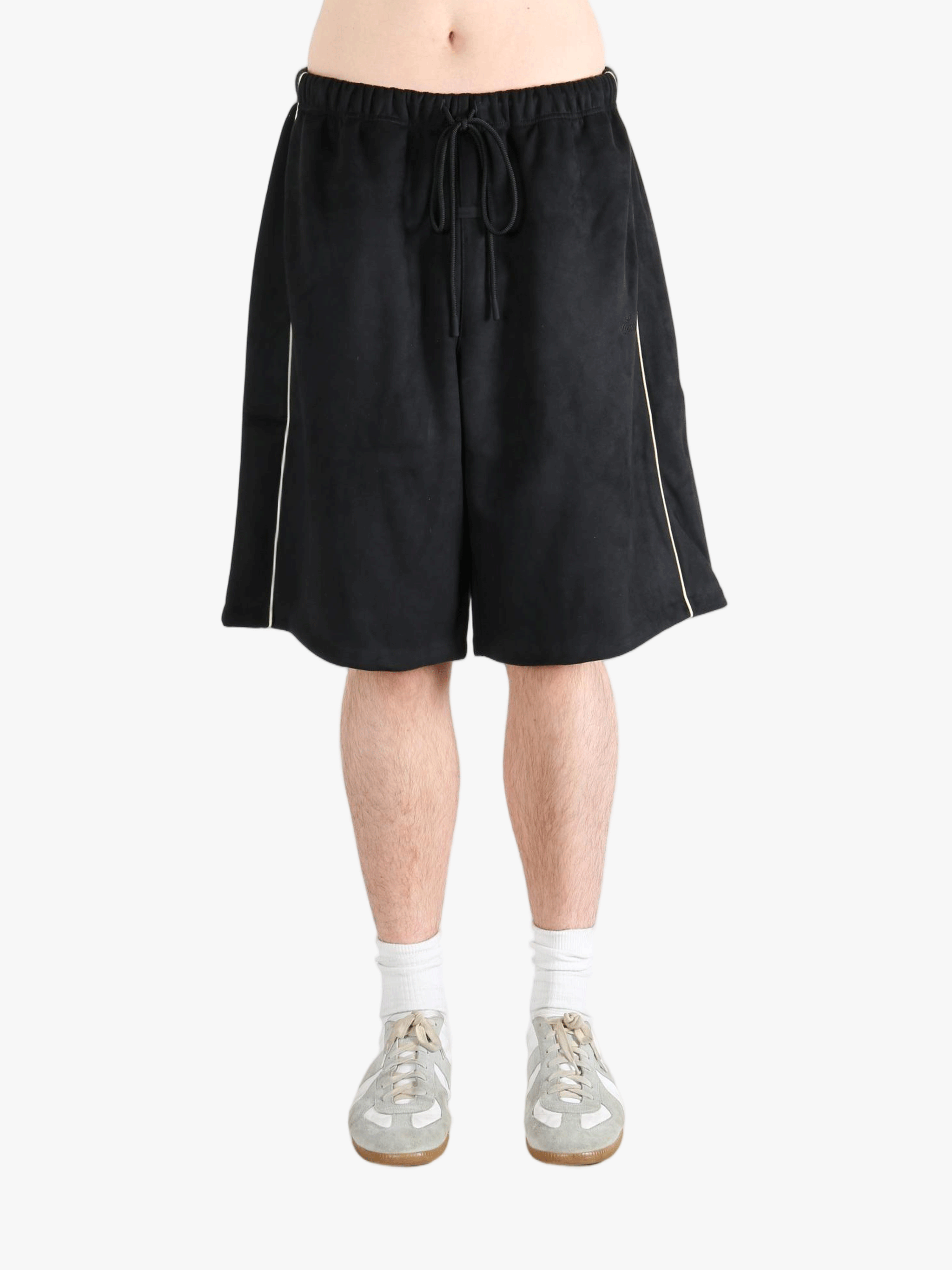 Black shorts worn by a person, showing the shorts fit