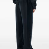 Black pants worn by a person, showing the pants fit