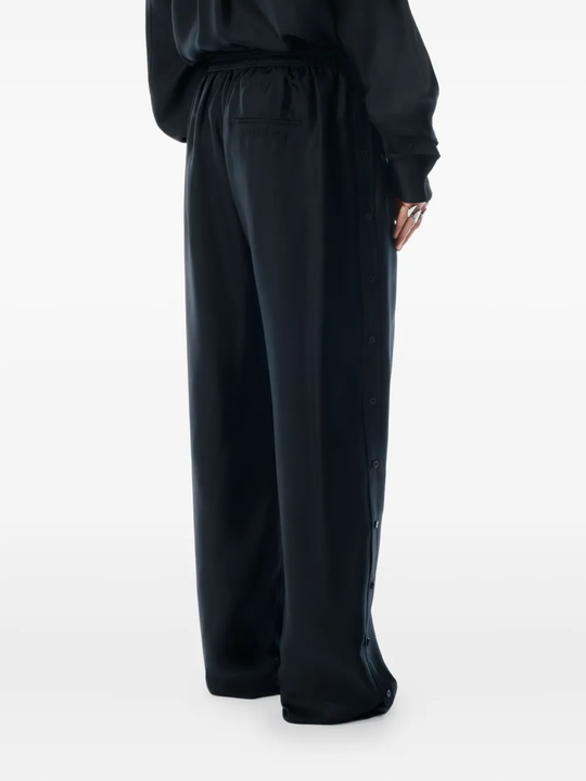 Black pants worn by a person, showing the pants fit