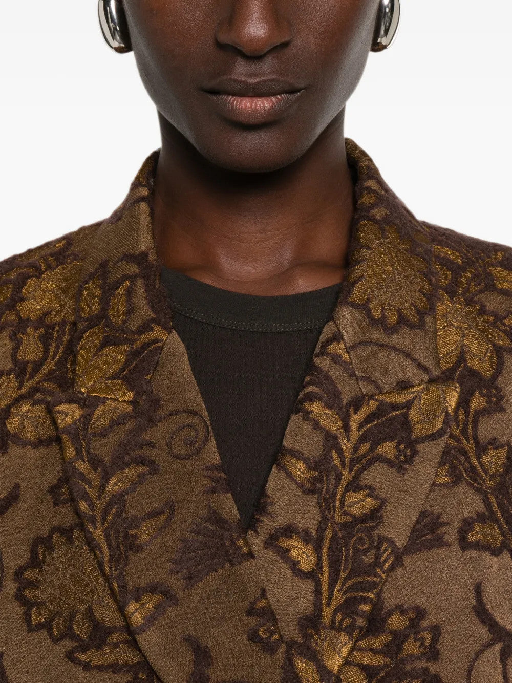 Brown jacket worn by a person, showing the jacket fit