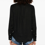 black shirt worn by a person, showing the shirt's fit