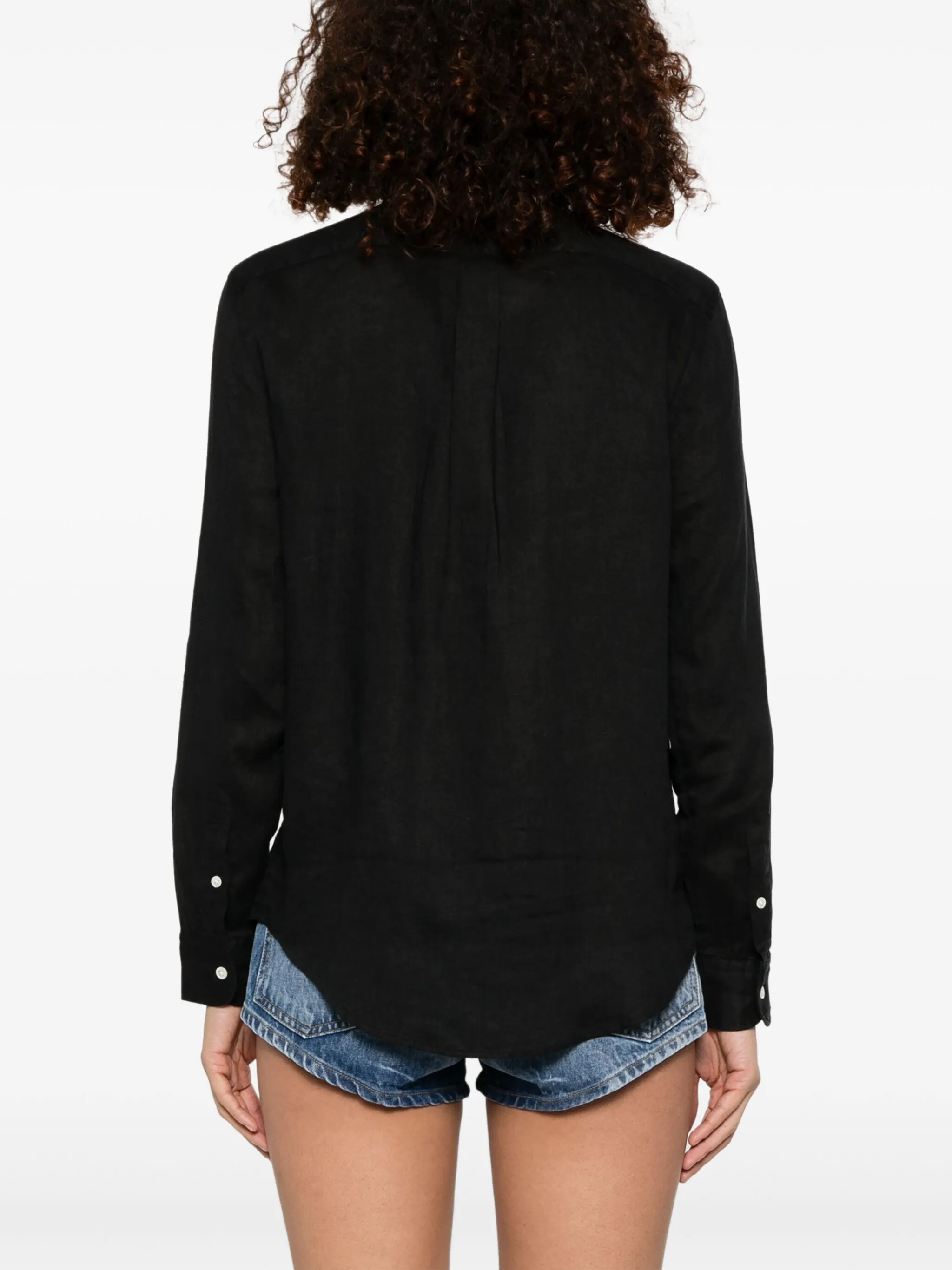 black shirt worn by a person, showing the shirt's fit