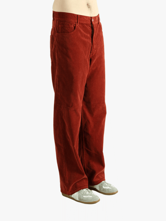Red pants worn by a person, showing the pants fit