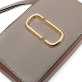 Close up of the grey bag, showing texture of the leather fabric