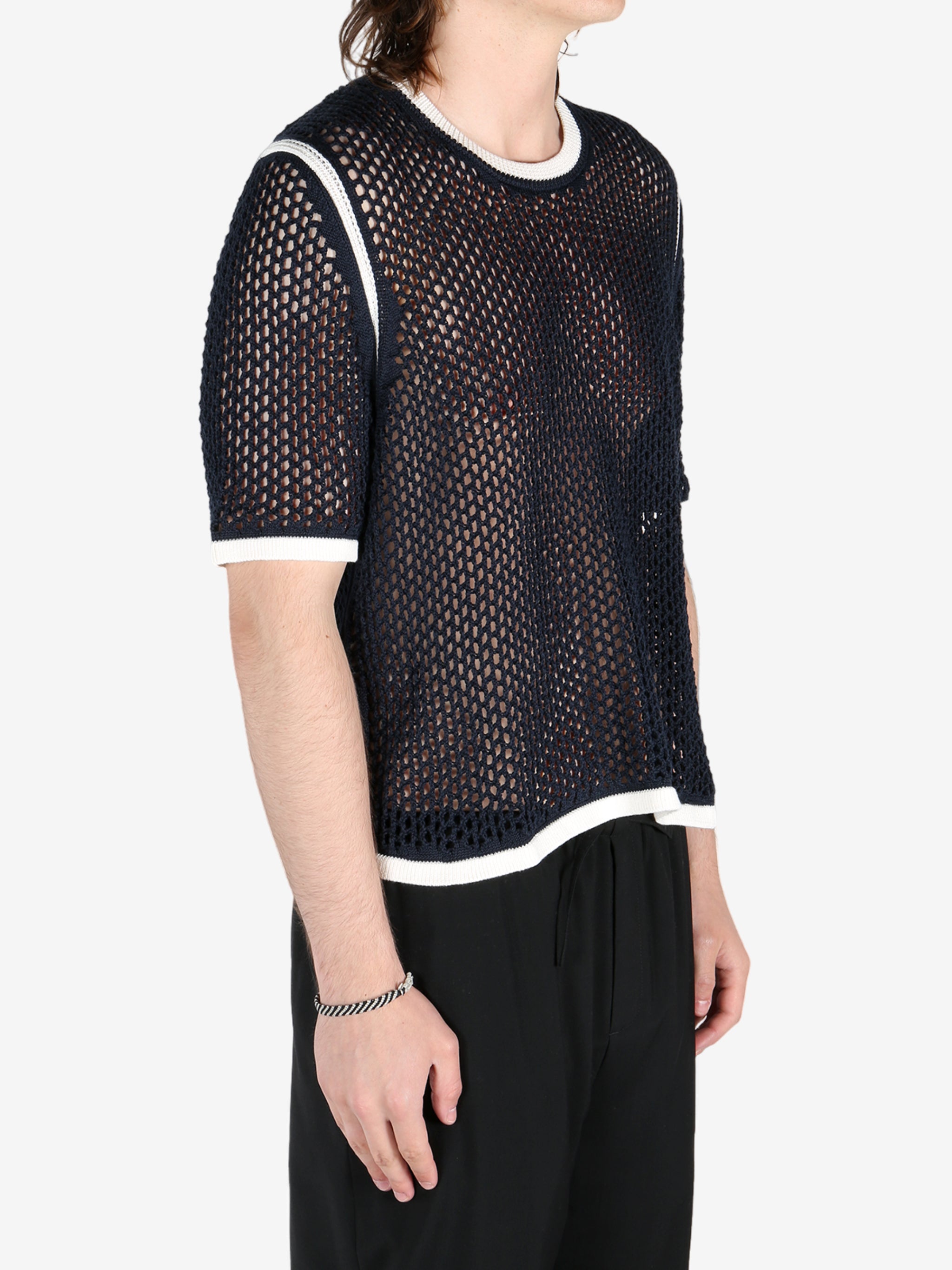 Black shirts worn by a person, showing the shirts fit