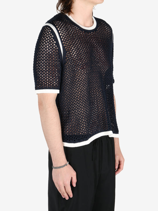 Black shirts worn by a person, showing the shirts fit