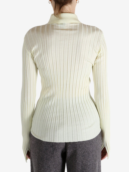 White shirt worn by a person, showing the shirt's fit