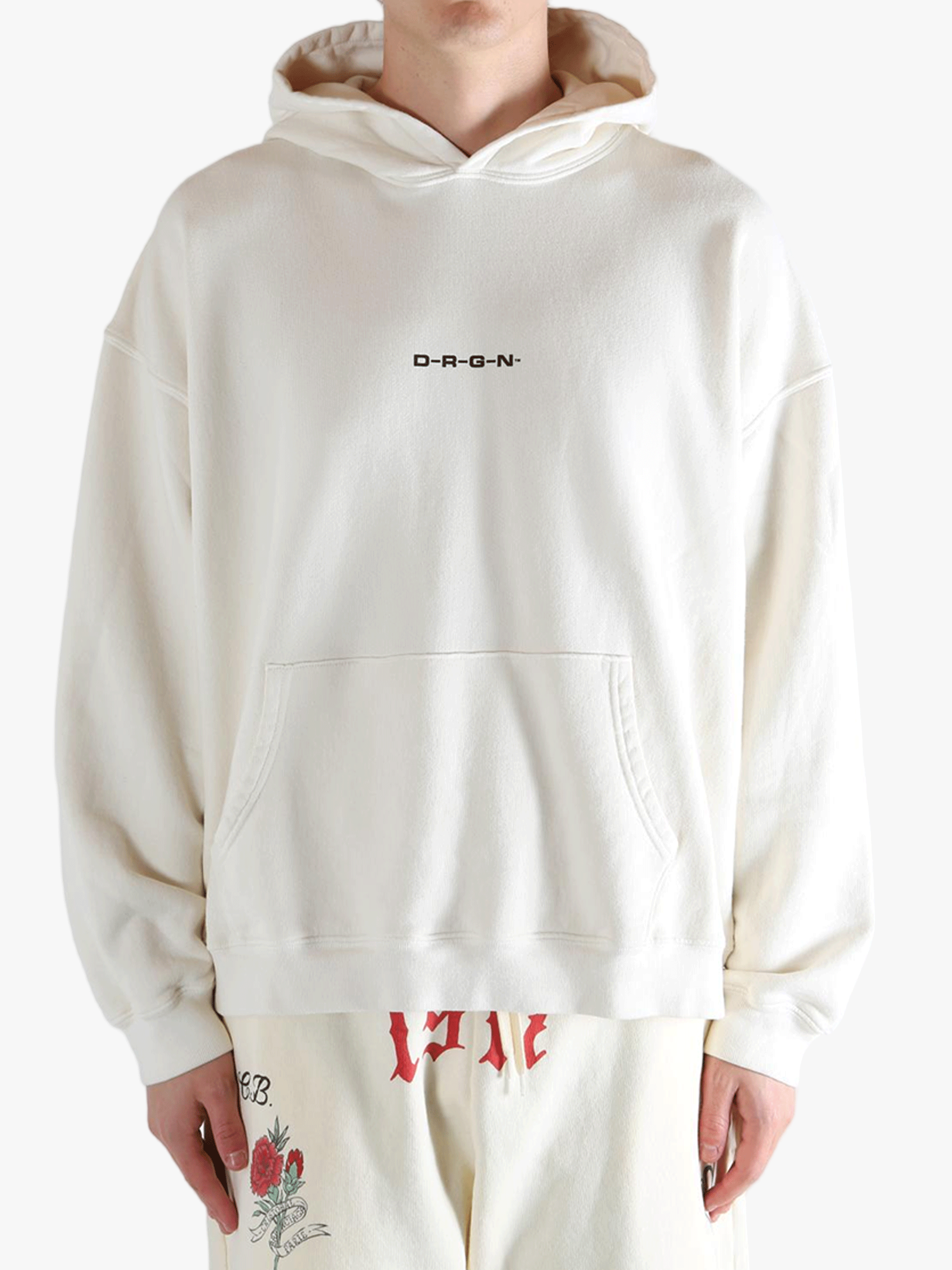 White hoodie worn by a person, showing the hoodie's fit