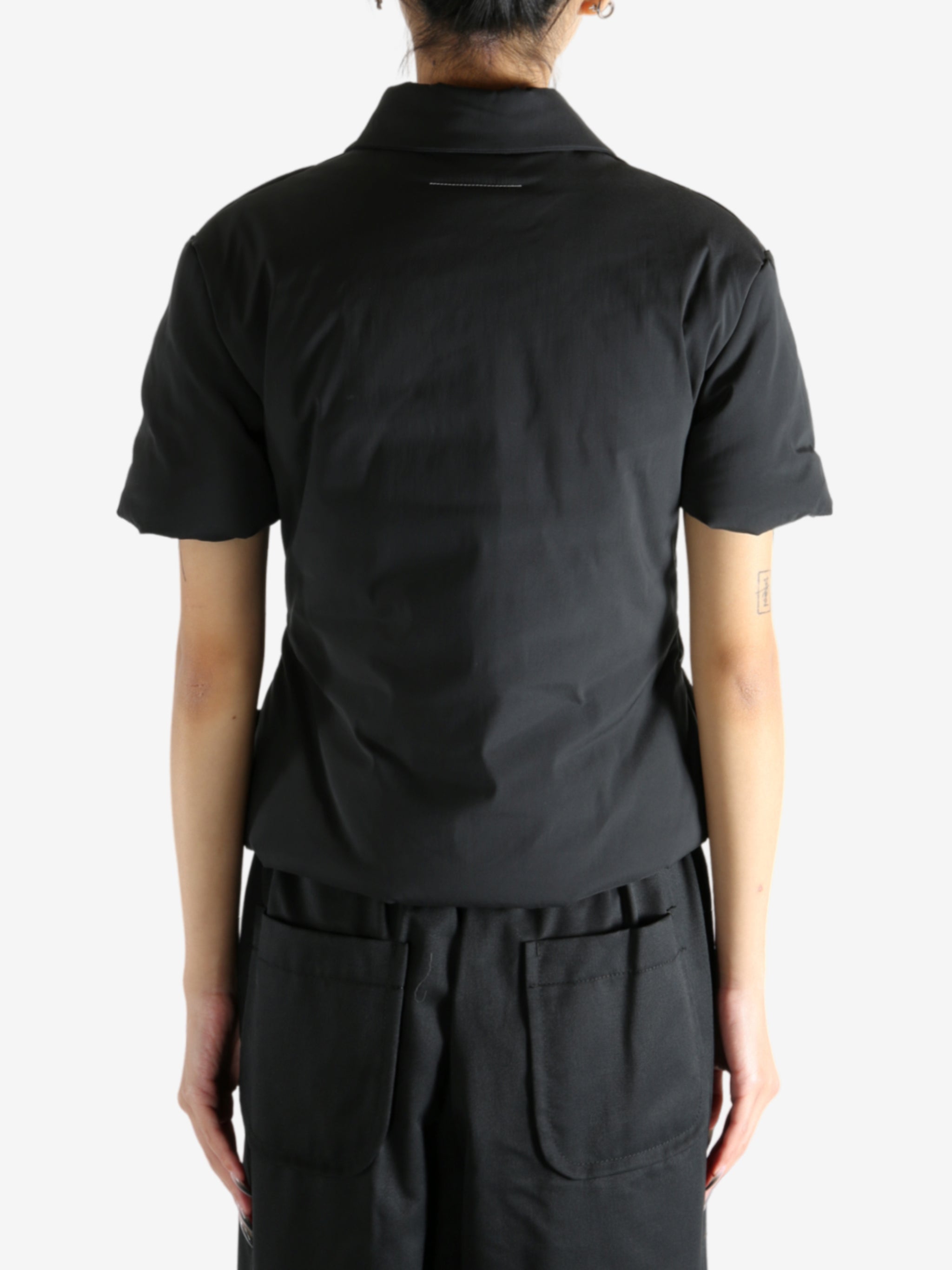 Black t-shirt worn by a person, showing the t-shirt's fit