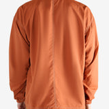 Orange jacket worn by a person, showing the jacket's fit