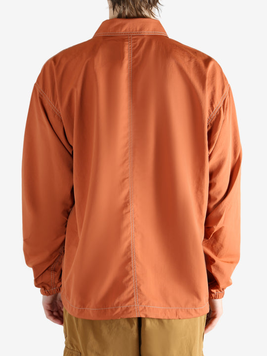 Orange jacket worn by a person, showing the jacket's fit