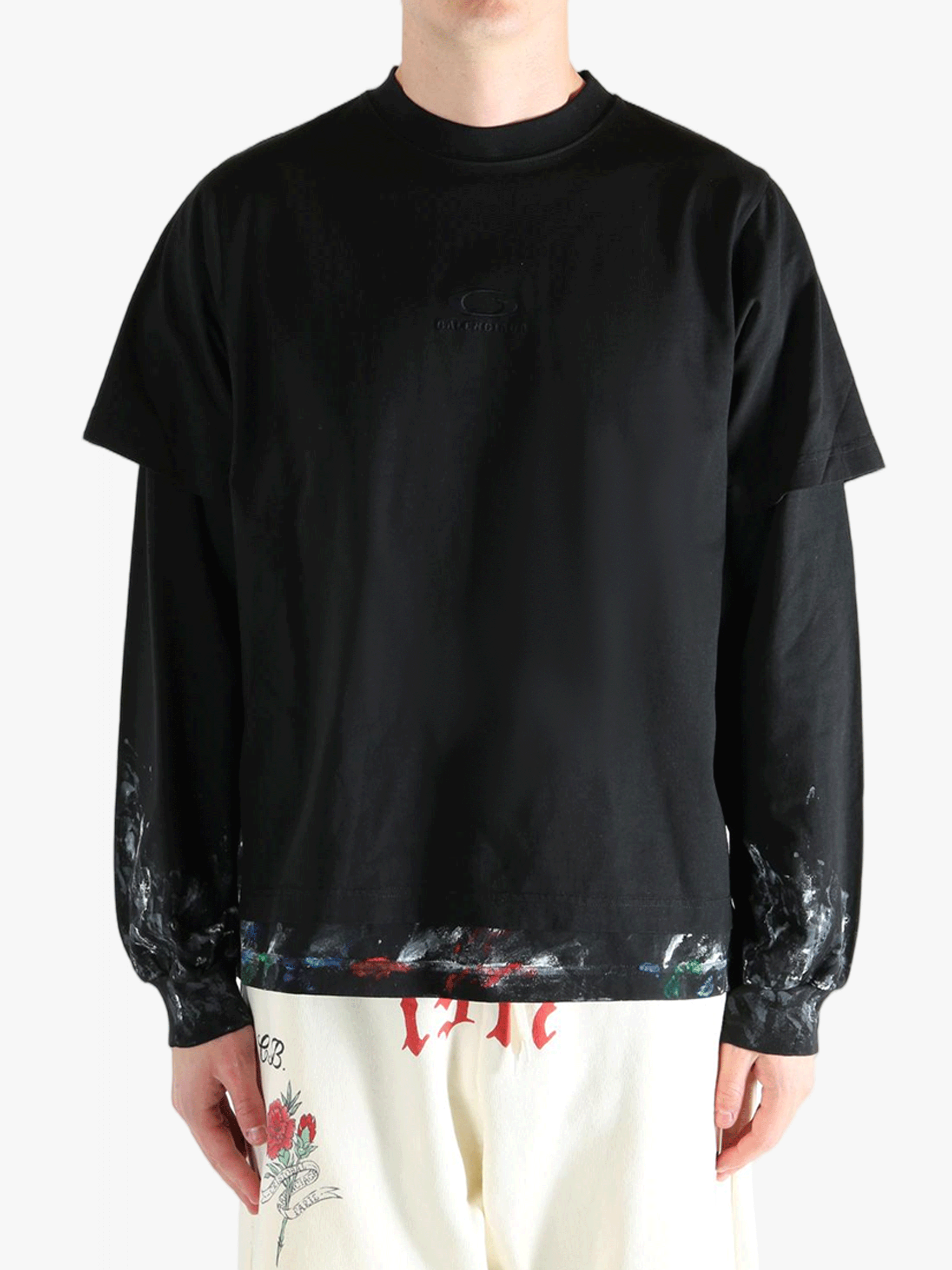 Black t-shirts worn by a person, showing the t-shirts fit