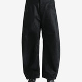 Black pants worn by a person, showing the pants fit