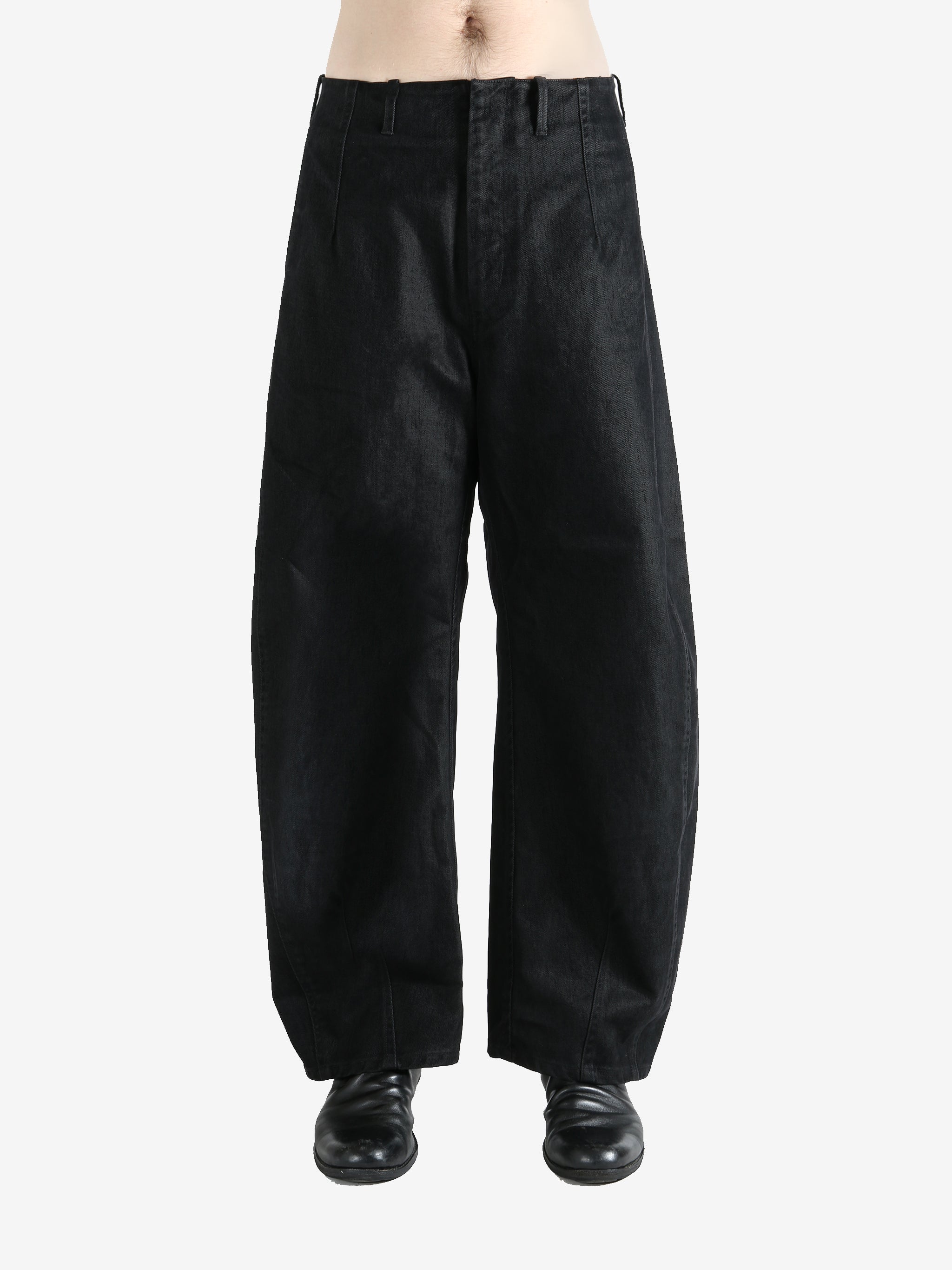 Black pants worn by a person, showing the pants fit