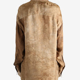 Brown top worn by a person, showing the top's fit