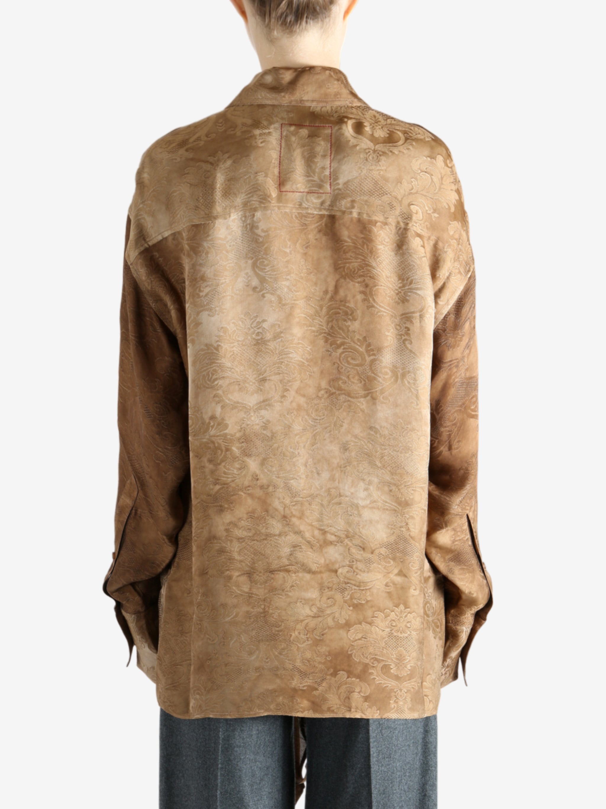 Brown top worn by a person, showing the top's fit