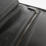 Close up of black bags, showing texture of the leather fabric