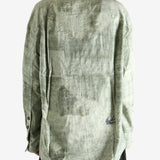 Green shirt worn by a person, showing the shirt's fit