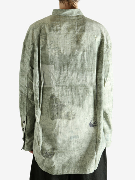 Green shirt worn by a person, showing the shirt's fit