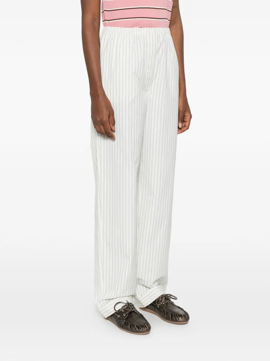 White pants worn by a person, showing the pants fit