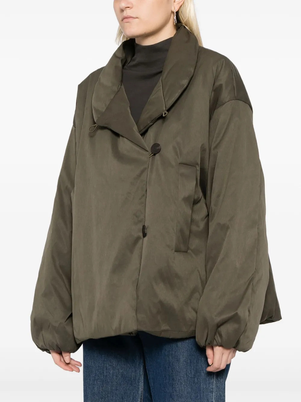Green jacket worn by a person, showing the jacket fit