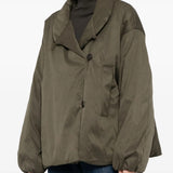 Green jacket worn by a person, showing the jacket fit