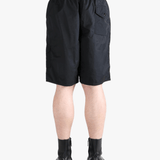 Black short worn by a person, showing the short's fit