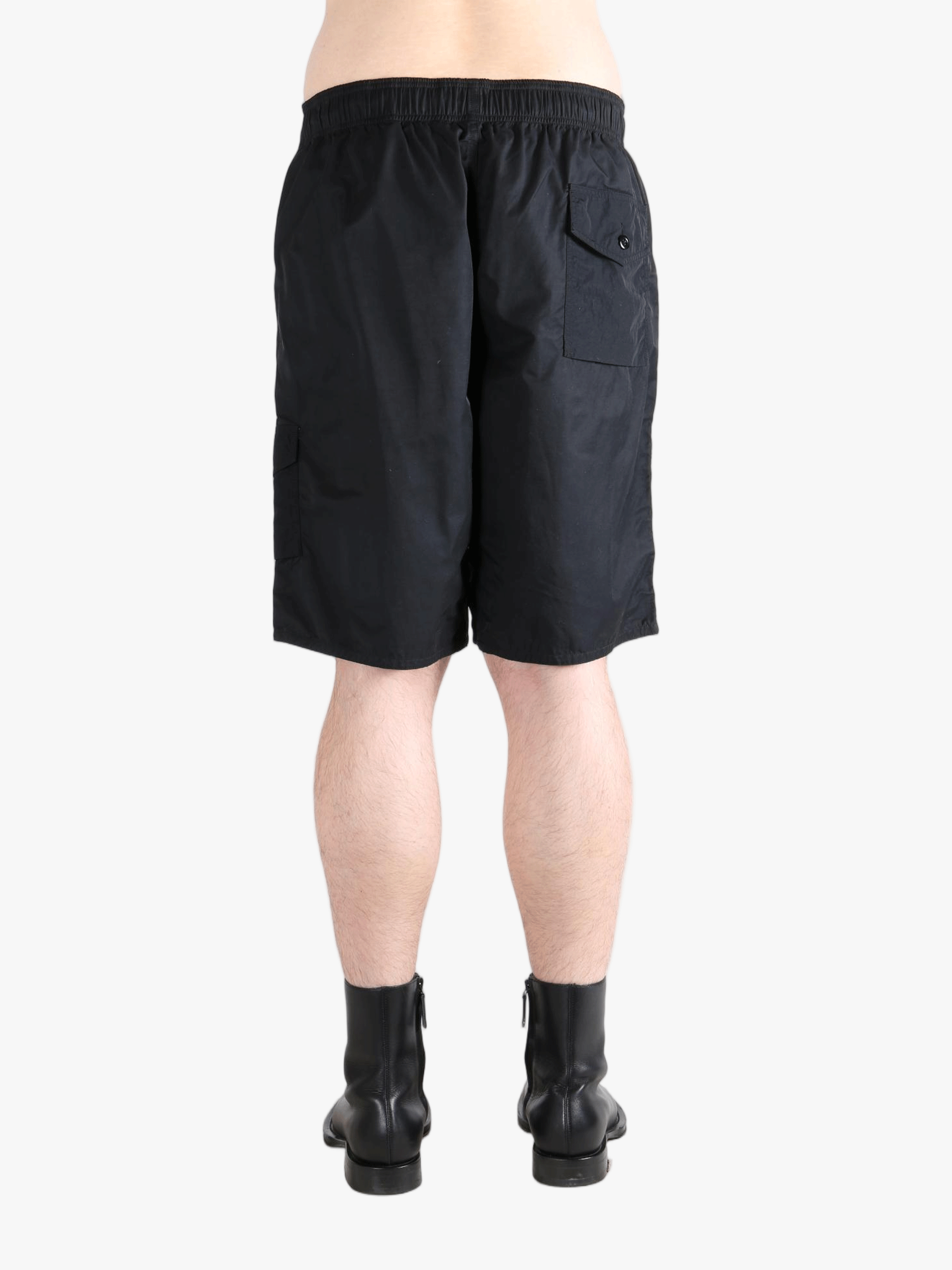 Black short worn by a person, showing the short's fit