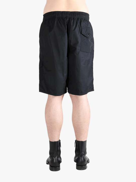 Black short worn by a person, showing the short's fit