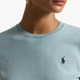 Green knitwear worn by a person, showing the knitwear fit