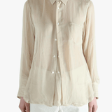 Tan shirt worn by a person, showing the shirt's fit