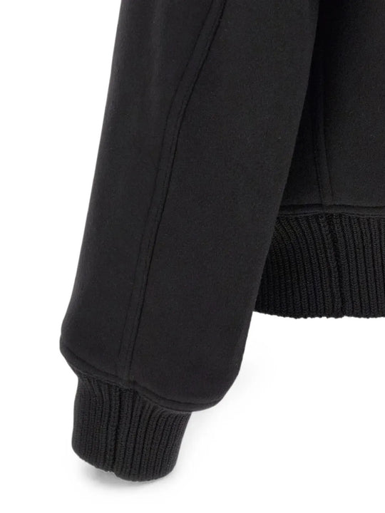 Close up of Black jacket, showing texture of the 100% wool fabric