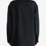 Black shirt worn by a person, showing the shirt's fit