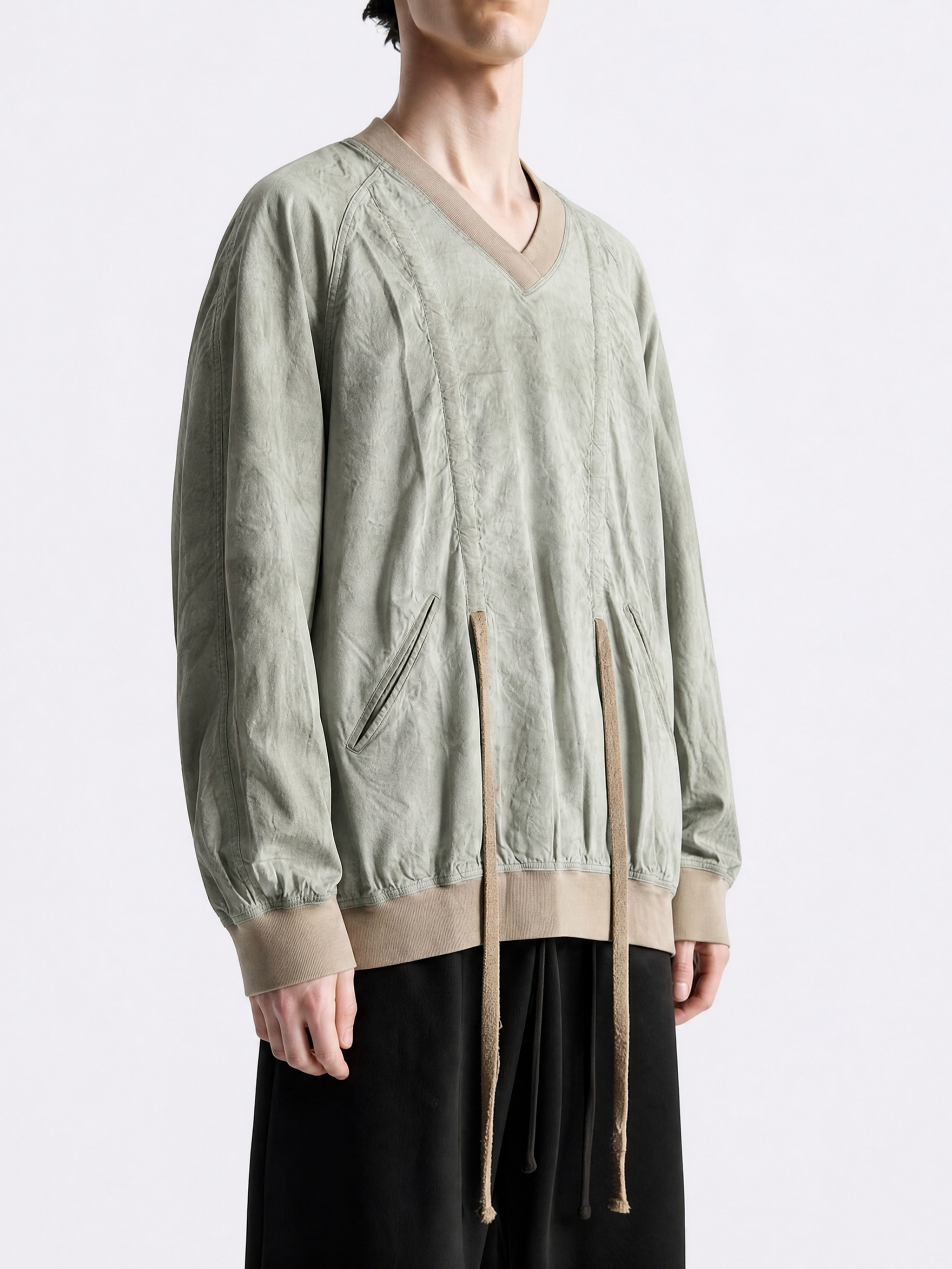 Green shirt worn by a person, showing the shirt fit