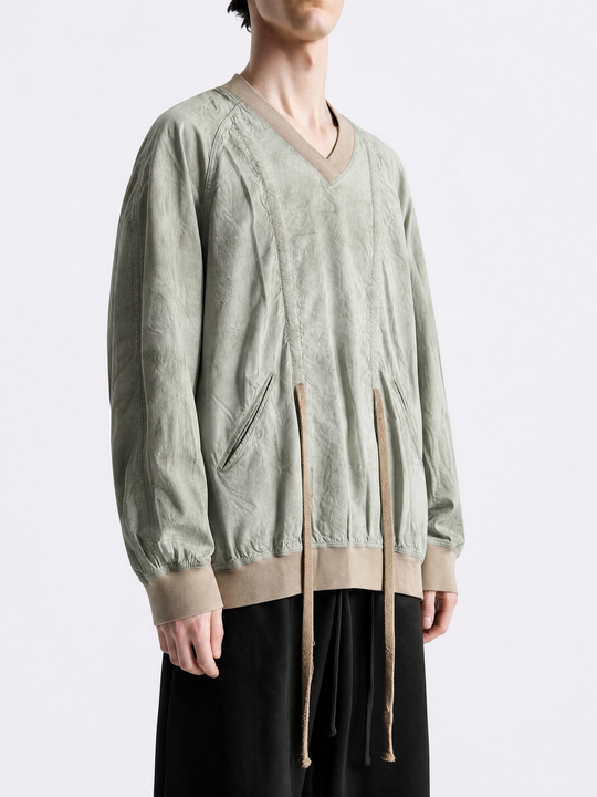 Green shirt worn by a person, showing the shirt fit