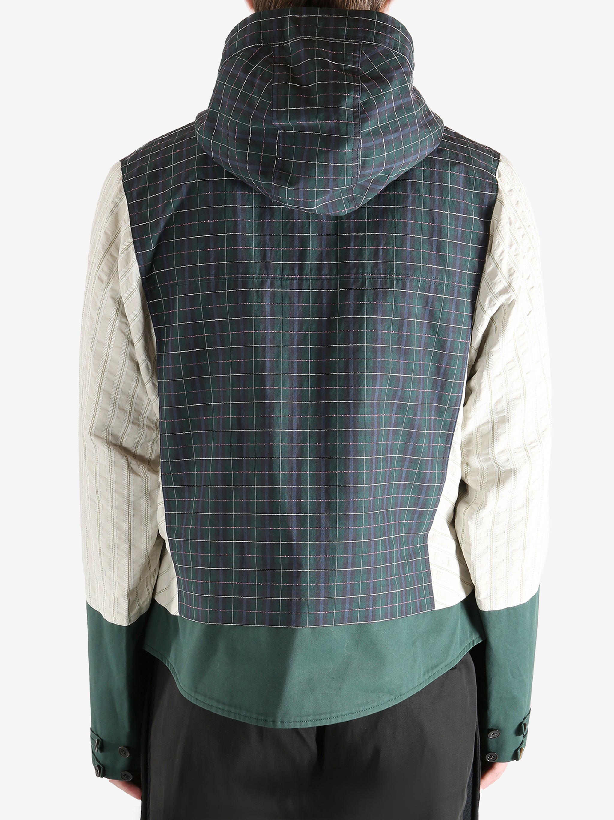 Green jacket worn by a person, showing the jacket's fit