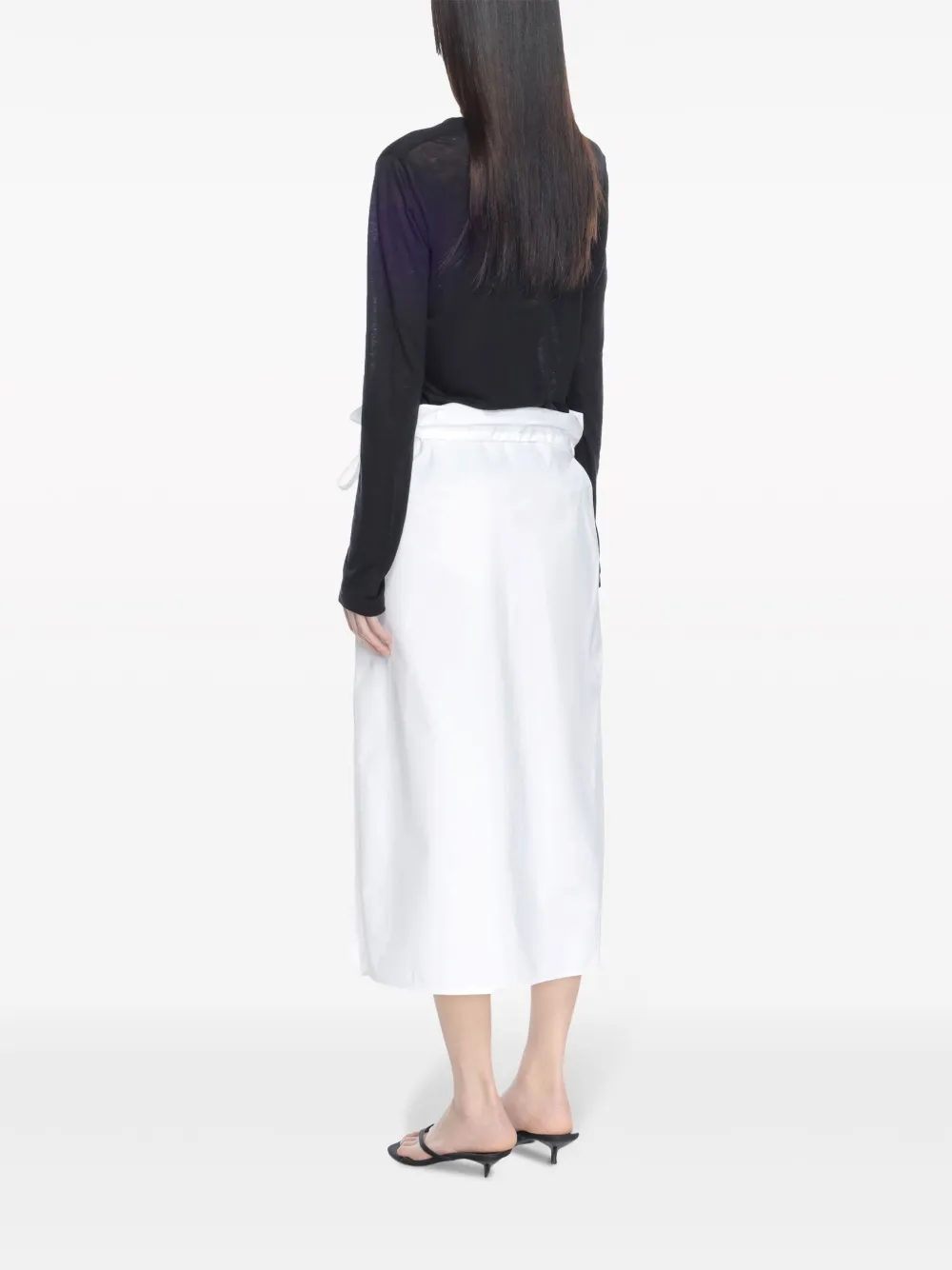 Black top worn by a person, showing the top's fit
