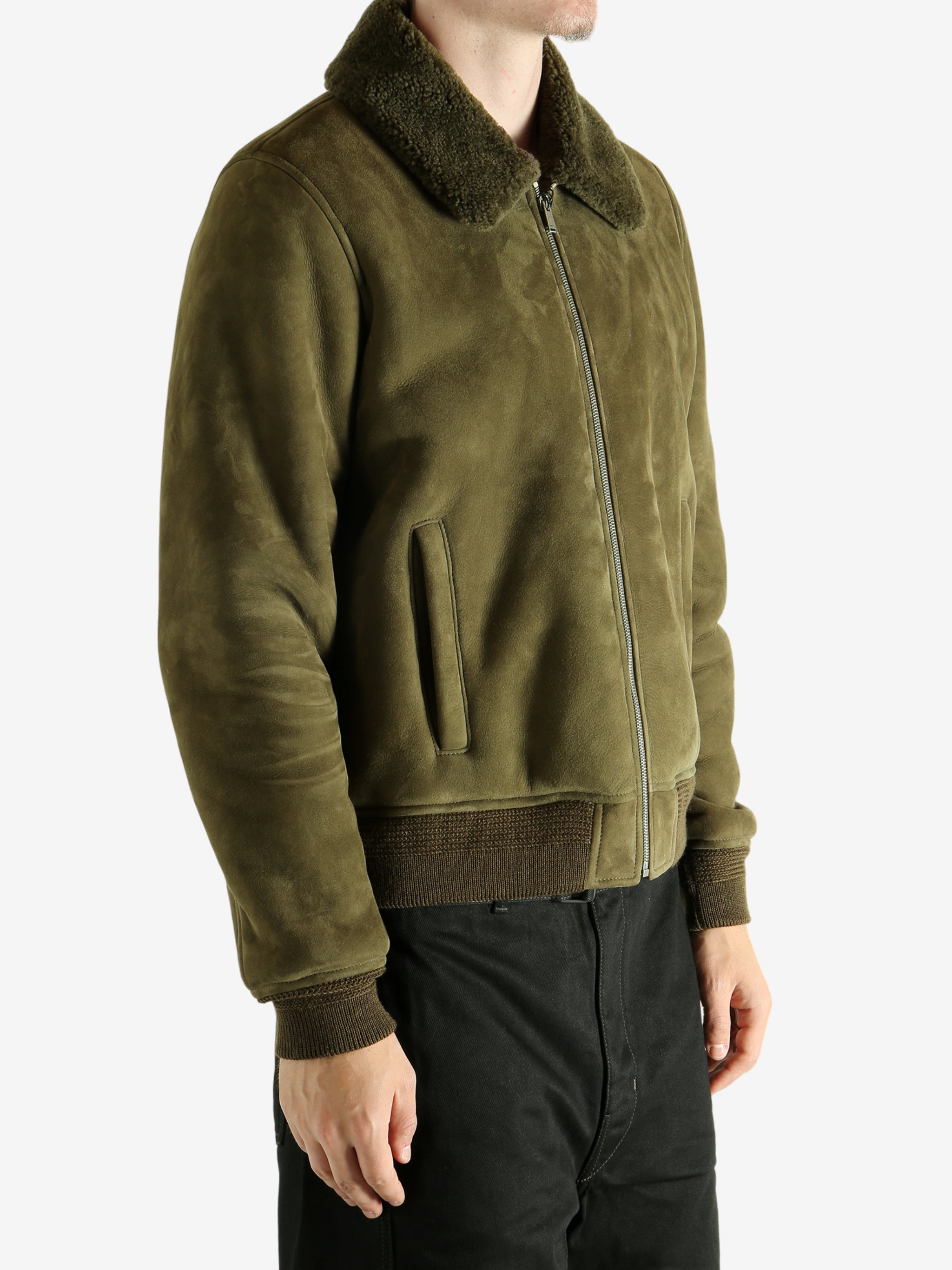 Green jacket worn by a person, showing the jacket's fit